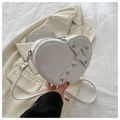 Witte hartvormige crossbodytas met zilveren klinknagels en accenten op een blazer - Wit