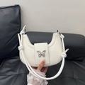 White semi-circle hobo bag with a silver butterfly buckle and knot strap design - Off White