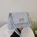 Minimalist light blue faux suede shoulder bag with a silver bow and metal chain strap - Blue