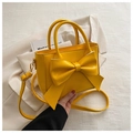 Elegante bolso de mano amarillo brillante con gran lazo de cuero y correa ajustable - Amarillo