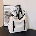 White nylon tote bag with black zippers and adjustable strap in modern utility style - White