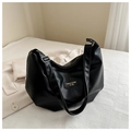 Detailed view of black matte PU leather tote bag with elegant golden logo on white fabric - Black