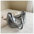 Detail of silver metallic tote bag featuring a Fashion & BaG logo on a white bedsheet - Silver
