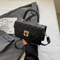 Classic black quilted handbag with golden floral clasp and detachable shoulder strap - Black