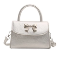 Metallic silver bow handbag with refined leather texture and detachable shoulder strap - Silver