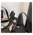 Elegant black crescent shoulder bag featuring a metallic silver flower clasp and strap - Black