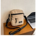 Beige canvas crossbody bag with black adjustable strap and front zipper pocket - Khaki