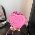 Pink heart-shaped bag featuring unique scrunchie handle and quilted surface detail - Rose Pink