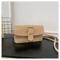 Close-up of a beige crossbody bag featuring a large golden square buckle on smooth leather - Khaki