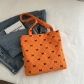 Orange corduroy tote bag with black diamond pattern and bow detail for summer - Orange