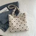 Chic cream tote bag with black quilted diamond pattern and cute bow details - Off White