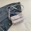 Pink butterfly printed crossbody bag with gold hardware on denim background - Pink