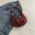 Deep red crescent handbag with crocodile texture and unique knot handle detail - Red