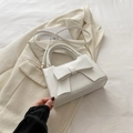 Elegant white rectangle handbag with a large decorative bow and gold-tone hardware - White