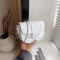 White litchi grain leather saddle bag with silver beaded chain strap and minimalist design - White