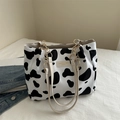 Fashionable cow print canvas tote bag with gold chain strap and chic leather brand tag - Cow Print