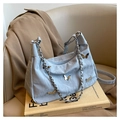 Detail of light blue butterfly tote bag with marble texture and golden charms on leather - Blue