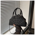 Close-up of contrast spider web stitching on black faux leather shoulder bag with gold hardware - Black
