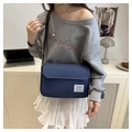 Minimalist navy blue oxford cloth messenger bag with flap closure and white woven label - Blue