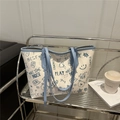 Blue and white graffiti print tote bag with cute cartoon motifs and sky blue handles - Blue