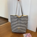 Classic black and white striped canvas tote bag with handmade oval metal emblem detail - Black