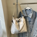 Minimalist beige drawstring crossbody bucket bag with adjustable wide canvas shoulder strap - Off White
