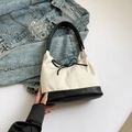 Minimalist canvas tote bag with black leather straps and decorative bow detail - Black