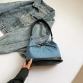 Blue denim tote bag with black leather base and delicate bow detail for daily commute - Blue