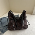 Large leopard print tote bag with silver zippers and black leather straps in a casual setting - Brown
