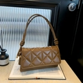 Brown quilted shoulder bag with knot strap detail and elegant minimalist flap design - Brown