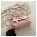 Detailed macro view of the pink crossbody bag featuring a golden bow metal clasp and PU leather - Pink