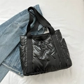 Chic black quilted tote bag with padded nylon texture and wide woven shoulder straps - Black