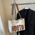 Große cremefarbene Canvas-Tote-Bag mit braunen HOOTO-Buchstaben und Ledergriff - Gebrochenes Weiß