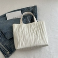 Minimalist white pleated tote bag with vertical textured design and wide top handle - White