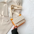 Fashionable woven straw crossbody bag with bright orange leather trim and wide strap - Orange
