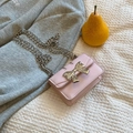 Chic light pink crossbody bag with silver bow accent and metal chain strap - Pink