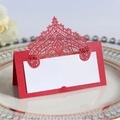 Elegant red laser cut lace wedding place card with a white blank insert on a plate - Pearlescent Red