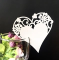 Detailed close-up of white heart-shaped laser cut card placed on a wine glass rim - White (BK96)