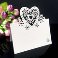 Elegant laser-cut heart and floral white wedding place card on reflective surface - Heart Floral Hollow Style (White XWK-5)