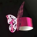 Pink metallic laser-cut butterfly napkin ring with intricate floral hollow patterns - Reflective Rose Red