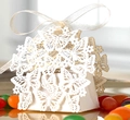 Elegant white laser-cut butterfly wedding favor box with a delicate white satin ribbon bow - White