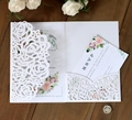 Laser-cut white rose invitation set with floral inner card and RSVP on wood background - White