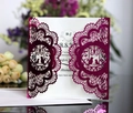 Detail of laser-cut wedding invitation with elegant birds and lace patterns in purple - Reflective Rose Red