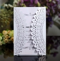 Detail of laser-cut white wedding invitation with elegant floral patterns and purple insert card - Lavender Inner Page Style
