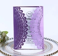 Detail of purple laser-cut wedding invitation with intricate floral patterns and card - Purple
