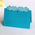 Peacock blue laser cut table card featuring intricate floral hollow patterns and folded design - Sky Blue