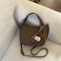 Detailed view of brown litchi grain leather bucket bag with cute plush ice cream charms - Brown (With Pendant)