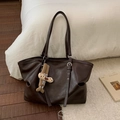 Close-up of vintage brown tote bag with glossy faux leather texture and plush charm - Coffee (With Pendant)