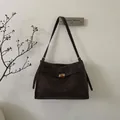 Detailansicht der dunkelbraunen Vintage-Tasche mit verstellbarem Gurt und Goldverschluss - Braun