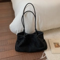 Detail of a large black matte tote bag with thin dual straps in a home lifestyle setting - Suede Black Without Pendant